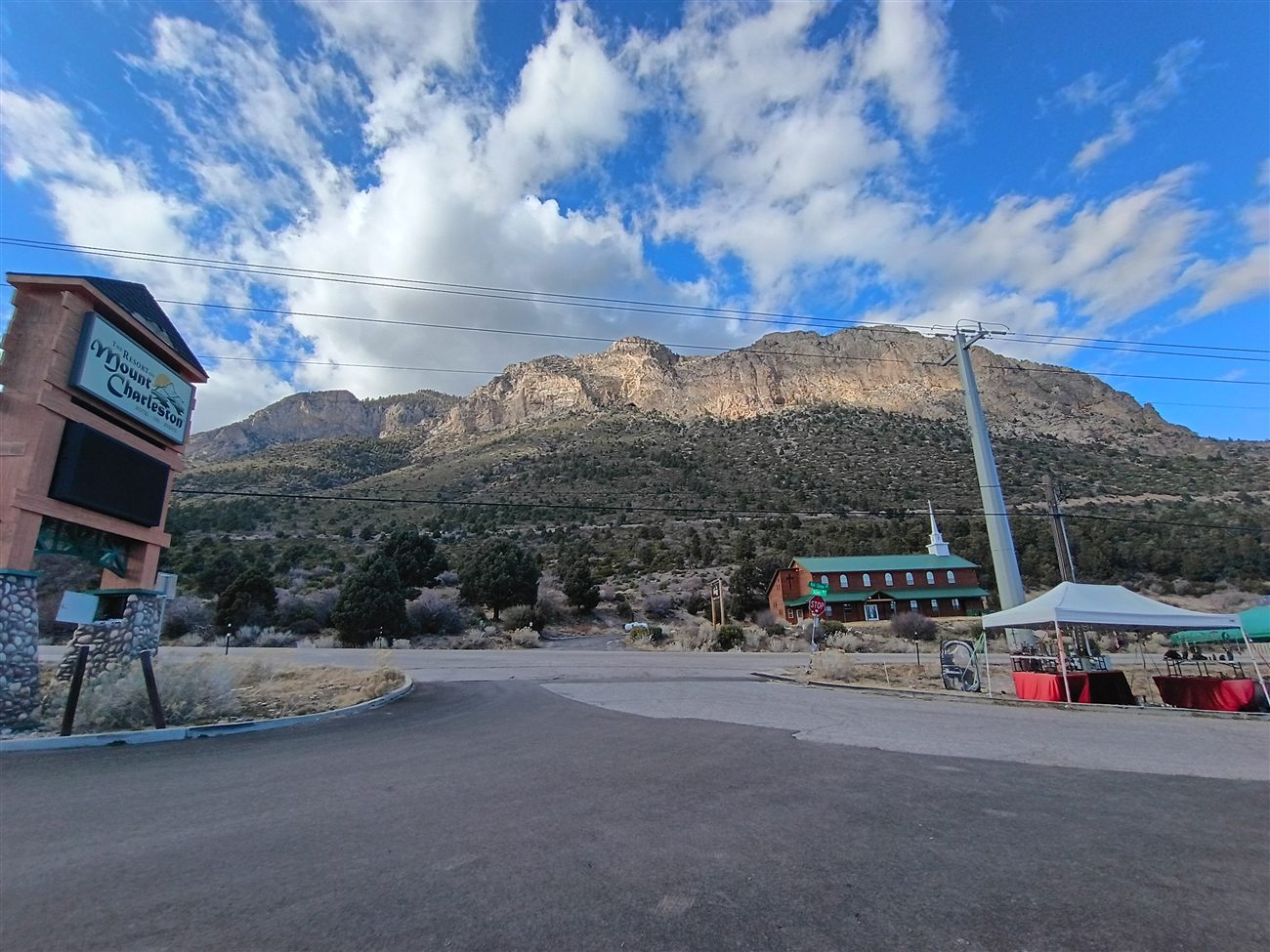 The Resort on Mount Charleston sign with a mountain ridge behind it
