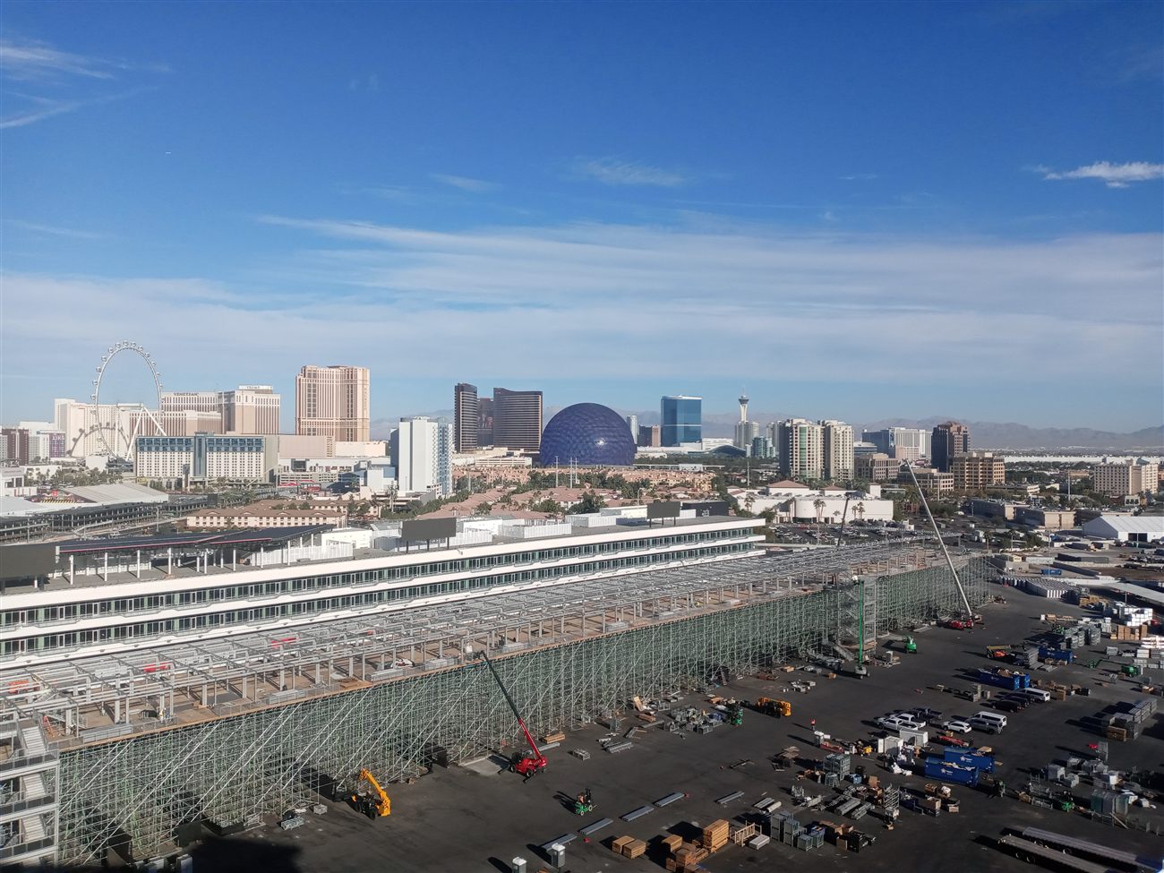 The Sphere in its bare grey state next to the High Roller, with F1 grandstand construction in the foreground