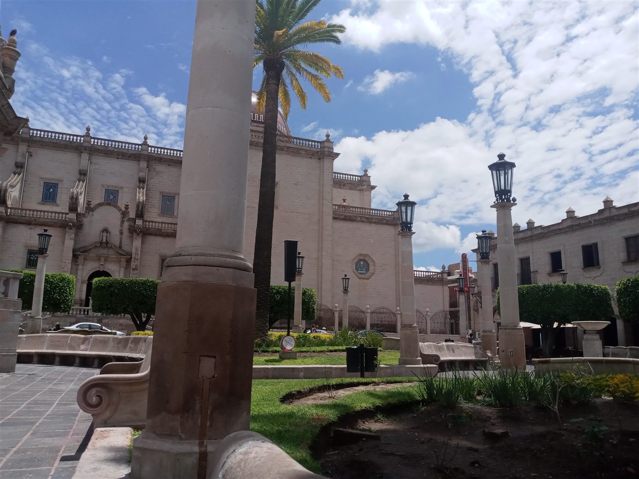 A colonial plaza facade with lamp posts