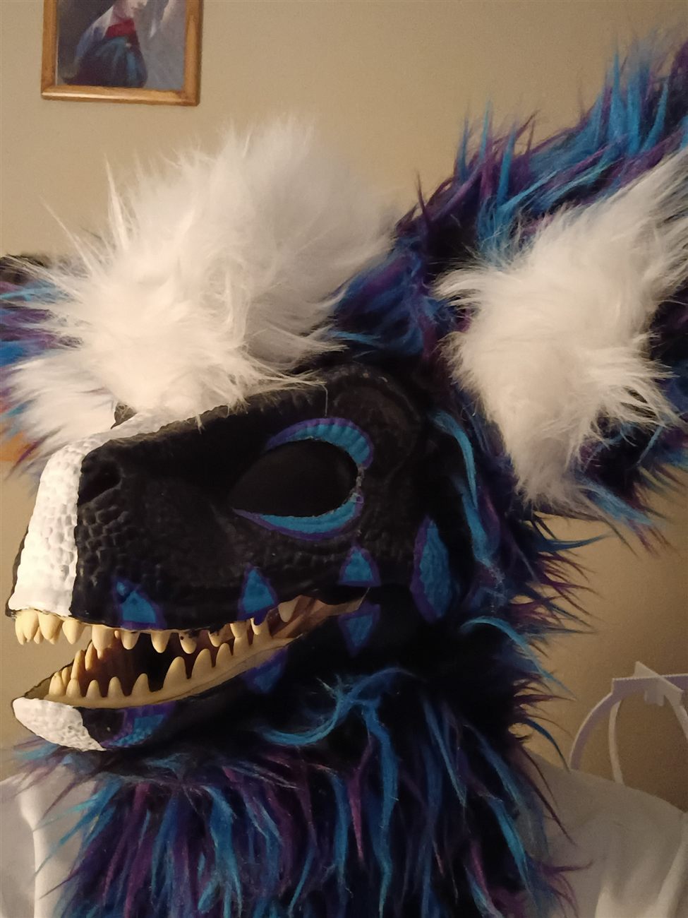Side profile of the custom fursuit head in progress, mouth open showing the teeth