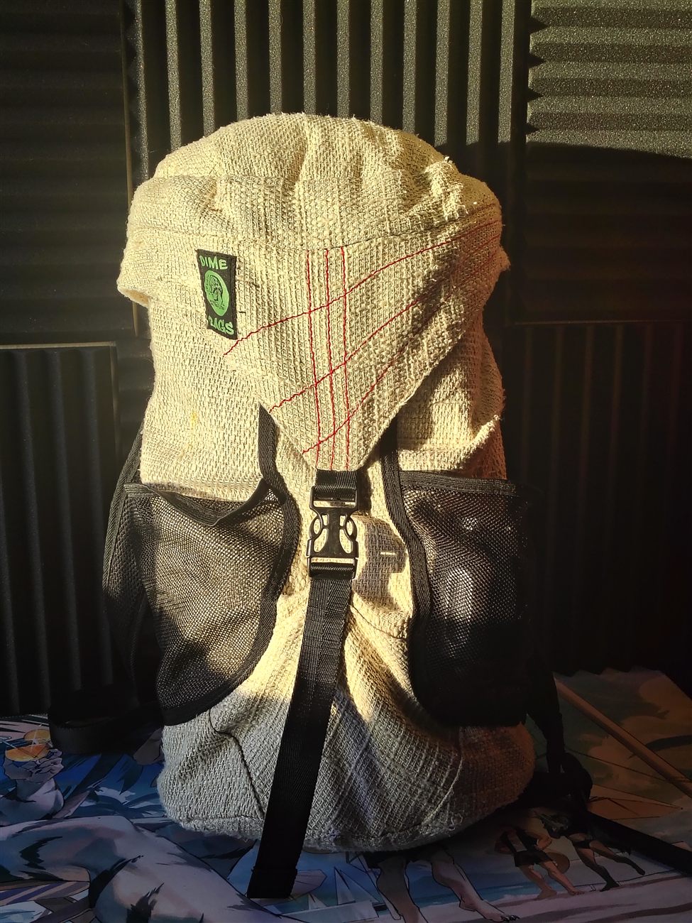 A woven canvas Dime Bags backpack with mesh side pockets